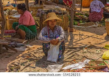 BAGAN, MYANMAR - FEBRUARY 24: Women are selling vegetables at the local market on February 24, 2013 in Bagan, Myanmar.