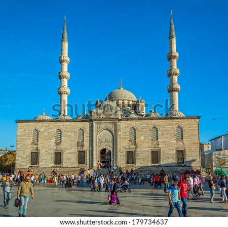 ISTANBUL, TURKEY - SEPTEMBER 26: Tourists and passers-by in the square in front of the New Mosque (Yeni Cami) in the Eminonu district on September 26th, 2013 Istanbul, Turkey.