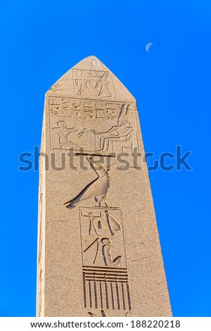 The Obelisk of Theodosius at Sultanahmet park and the moon in the blue sky. It is the Ancient Egyptian obelisk of Pharaoh Tutmoses III.