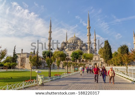 ISTANBUL, TURKEY - SEPTEMBER 27, 2013: Tourist group walking around Blue mosque and Sultanahmet park. The biggest mosque in Istanbul of Sultan Ahmed (Ottoman Empire).