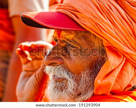 HARIDWAR, INDIA - APRIL 12, 2010: Sadhu portrait in orange clothes on the Kumbh Mela - is a mass Hindu pilgrimage of faith in Which Hindus gather to bathe in the sacred river.