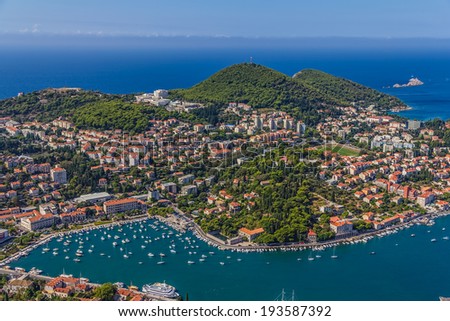 Aerial helicopter shoot of Dubrovnik harbor, tourist and residential area. Hill Petka in the back.