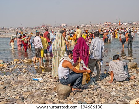 HARIDWAR, INDIA - APRIL 14, 2010: People performing a religious ritual in the holy river Ganga at the Kumbh Mela, a mass Hindu pilgrimage of faith.