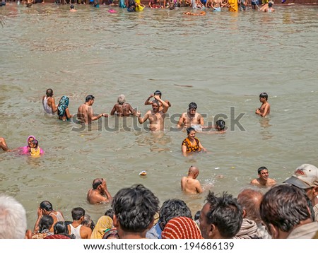 HARIDWAR, INDIA - APRIL 15, 2010: People performing a religious ritual on Main bathing Ghat in the holy river Ganga at the Kumbh Mela.