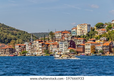ISTANBUL, TURKEY - SEPTEMBER 29, 2013: Fishing boat in front of the old waterfront houses in Yenikoy.