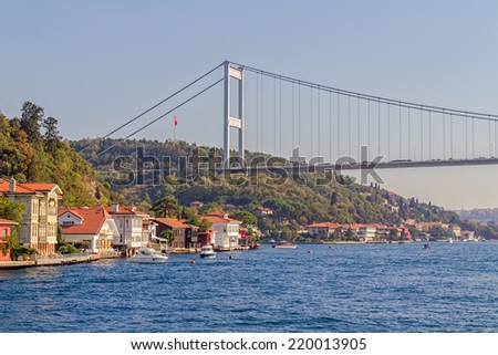ISTANBUL, TURKEY - SEPTEMBER 29, 2013: View of the first raw of the waterfront houses in Kanlica and Fatih Sultan Mehmet Bridge sailing Bosphorus.