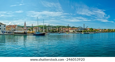 SUPETAR, CROATIA - September 16, 2014 People in the quiet port of the old town by the sea in the summer day on island Brac.