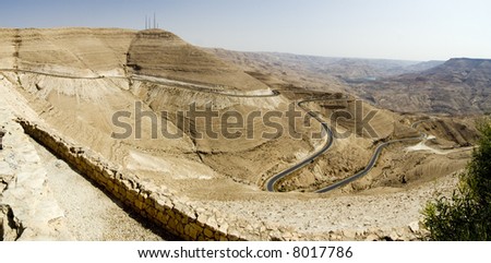 Canyon landscape  in Jordan with road going down. Hill-side slope also going down in perspective (that is why horizon is not horizontal)