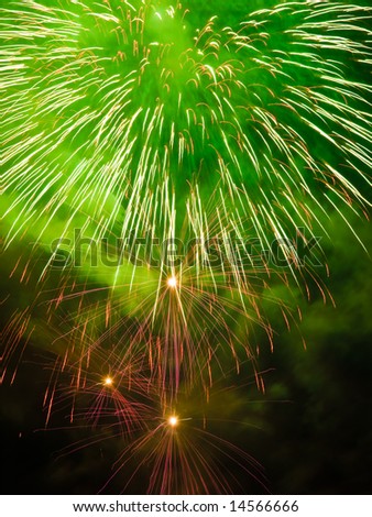 Fireworks rockets exploding against dark sky.
