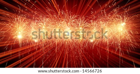 Digitally enhanced firework.  Red row of rockets with light rays in background.