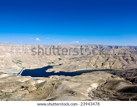 Wadi Mujib - King \'s road area, highway  on the water dam with desert landscape around it in Jordan.