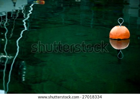 Orange buoy in a marine with copy space around it