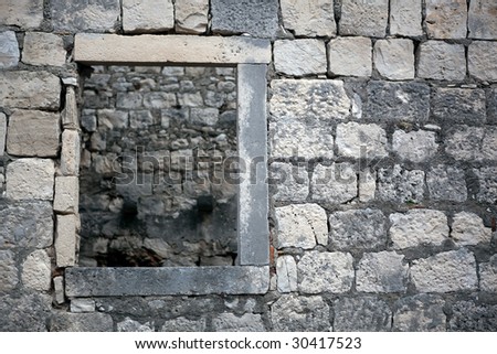 Traditional old stone window ruined. Can be used ad old medieval background with frame. Location: Korcula island, Croatia
