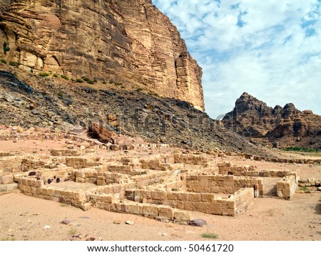 Wadi Rum desert hills with ruins of nabatean temple in Jordan