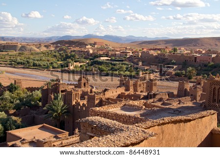 Fortified City (Ksar) with Mud Houses in the Kasbah Ait Benhaddou near Ouarzazate against new village, Morocco. Souss-Massa-DraÃ¢ region. Ounila River. UNESCO World Heritage Site since 1987