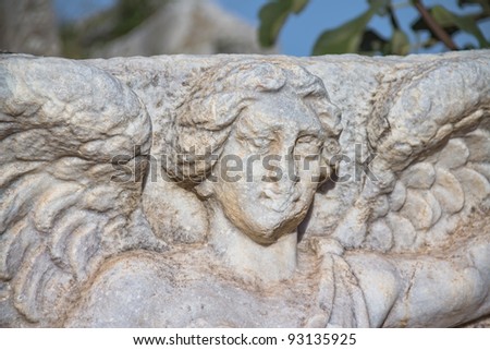 Sculpture detail of female head in Ephesus (Efes) from Roman time in Turkey. Woman head with wings.