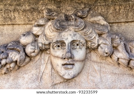 Building relief detail with human head of architectural frieze in Aphrodisias (Turkey) build during Roman period.