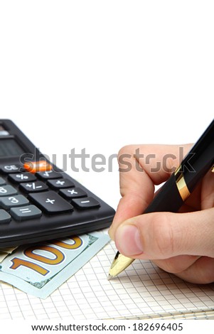 Dollars, calculator and hand with pen on the open notebook.