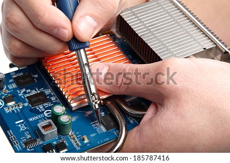 Soldering iron in hand and electric board on a white background.