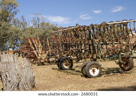 ploughs and farm machinery in a row