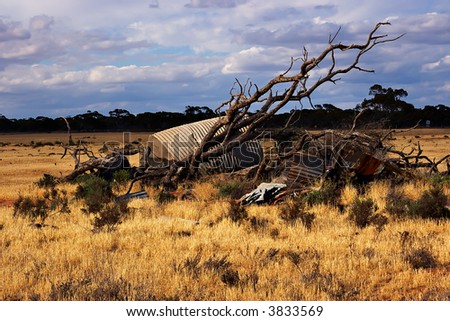 an old fallen tree and  pile of rubbish in the middle of a field
