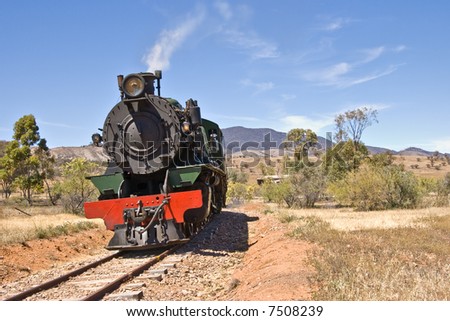 an old steam train goes through the australian outback