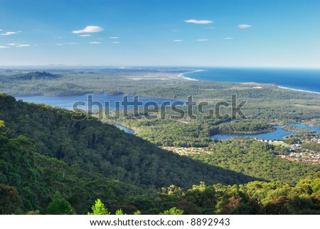 aerial viewpoint looking to the coast over a forested landscape