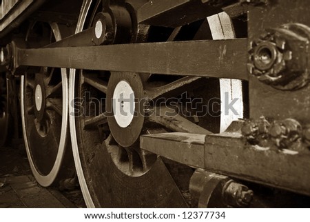 great steam train locomotive wheels closeup image in rich sepia