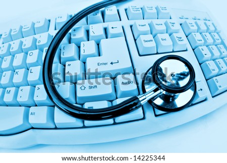 medical technology or computer problems stethoscope and keyboard on clinical blue