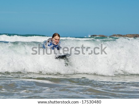 a girl in the waves at the beach