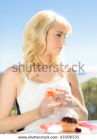 beautiful young woman with wine and profiterole