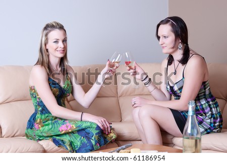 two young women chatting over cheese and wine