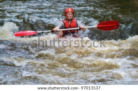 teenager white water kayaking