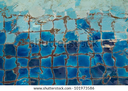 Swimming pool with blue ceramic tiles and water ripple effect