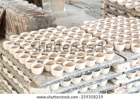 Ceramic cup in rack  prepare for bring in furnace in factory