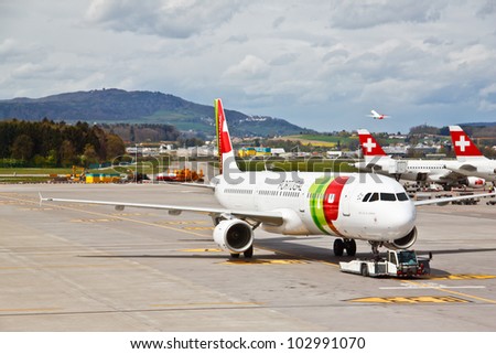 ZURICH - APRIL 22: Commercial air crafts at Zurich airport on April 22, 2012 , Switzerland.  The airport is Switzerland\'s largest international flight gateway and hub to Swiss International Air Lines