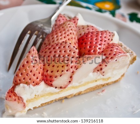 piece of white strawberry tart with custard filling on white dish