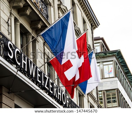 ZURICH-APRIL 21: Swiss and Zurich flags in front of Hotel Schweizerhof in Zurich, Switzerland on April 21, 2012. Zurich is home to a large number of financial institutions and banking giants.