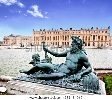 bronze sculpture in the garden of Versailles palace near Paris, France with blue sky (composition)