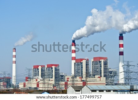 power plant with smoke from its stacks