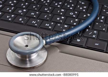 medical concept, stethoscope resting on laptop computer for internet medical diagnosis