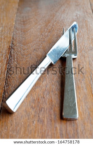 Set of steel metal cutlery on table wood