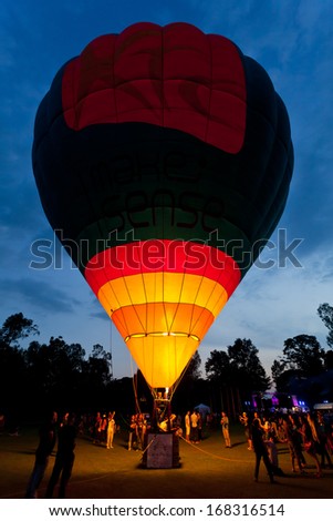 CHIANGMAI, THAILAND-DECEMBER 7: People watch the Hot air balloons flying at Thailand International Balloon Festival in Chiang Mai on December 7, 2013 in Chiangmai,Thailand