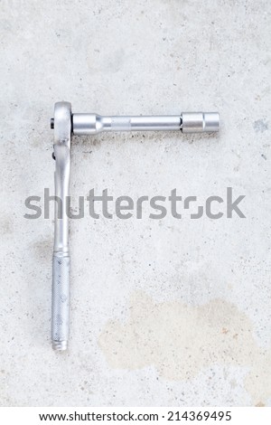 Ratchet (Socket Wrench) on Cement Background
