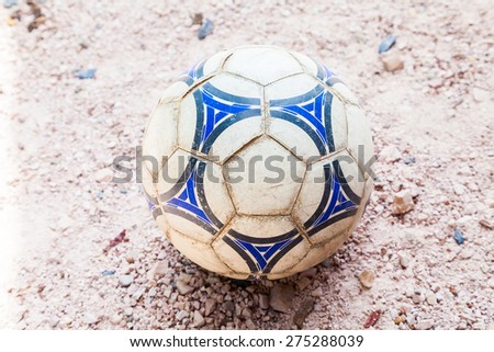 Old soccer ball on the ground