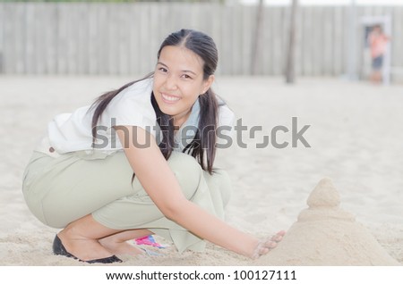 Happy Asian Woman play Castle Sand in Songkran Festival on Hua Hin beach