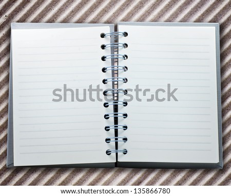 notebook on brown paper texture background