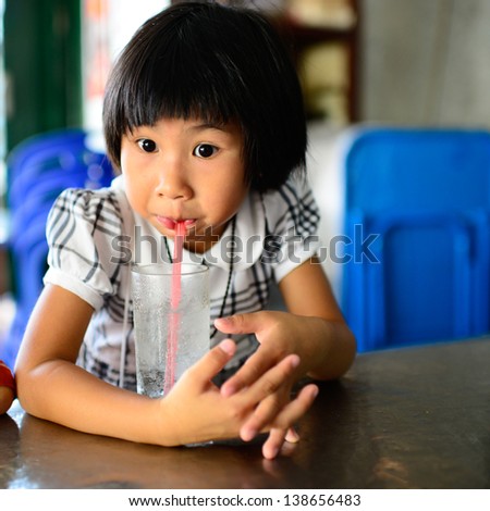 Young asian girl drinking water
