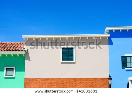 pink green blue house with blue sky in sunny day