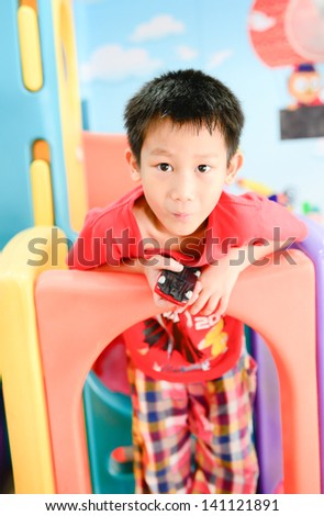 Asian boy enjon with indoor playground
